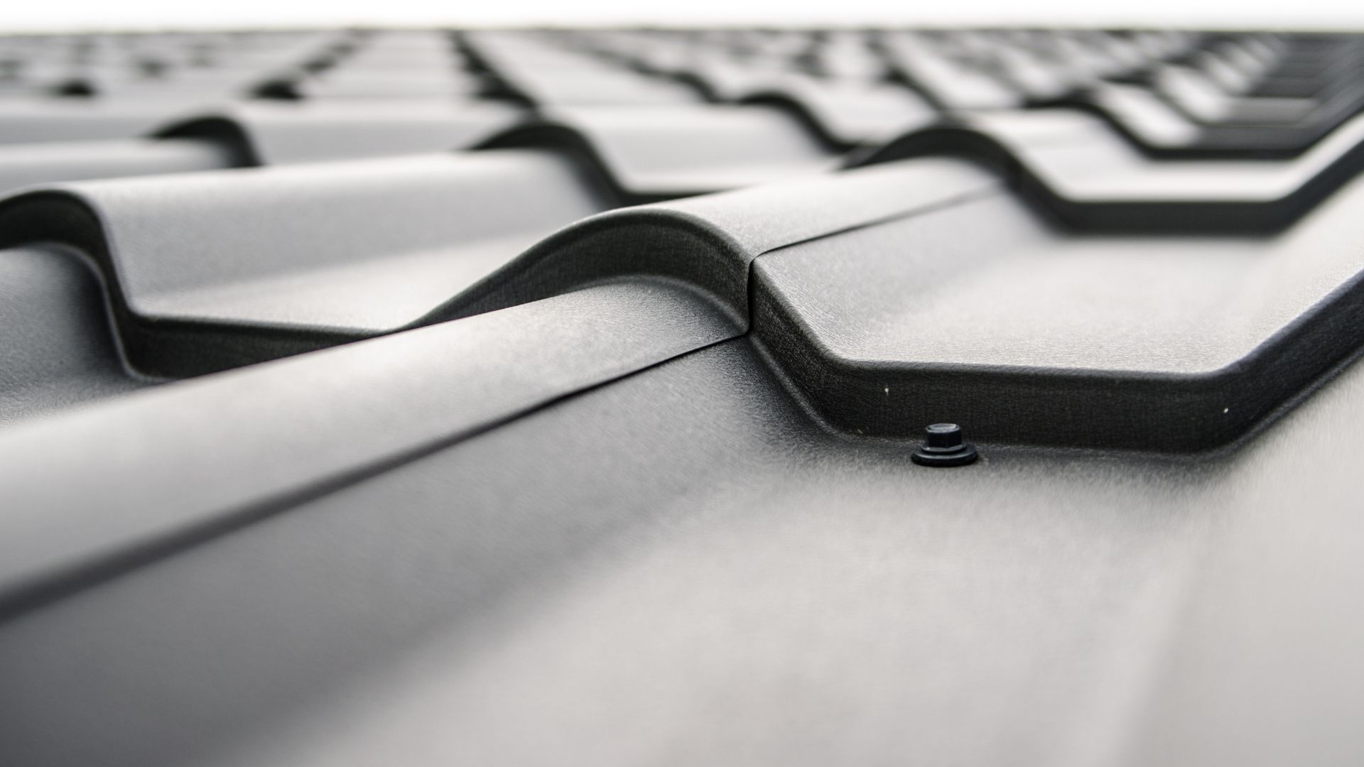 A close up of a metal roof with a white background